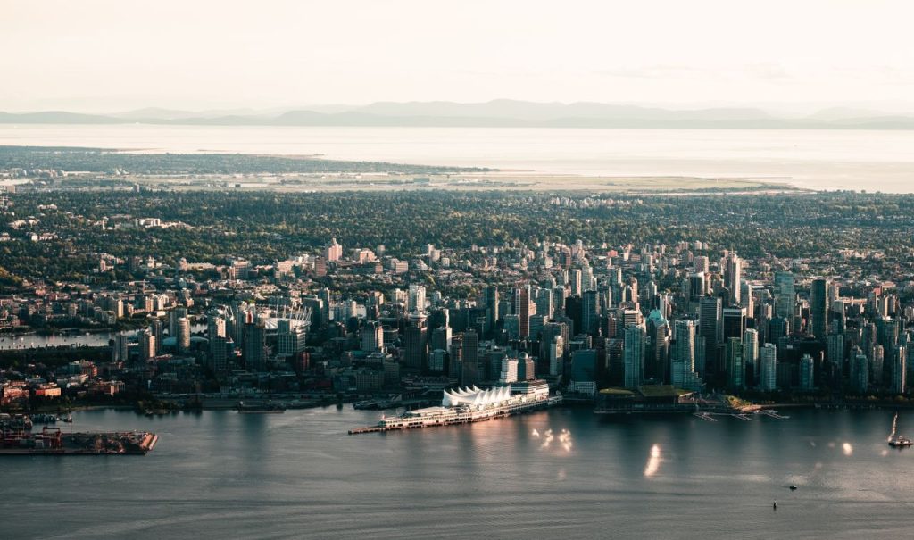 Crafting Captivating Headlines: Your awesome post title goes here Scenic aerial shot of Vancouvers skyline with waterfront and mountains in the background.