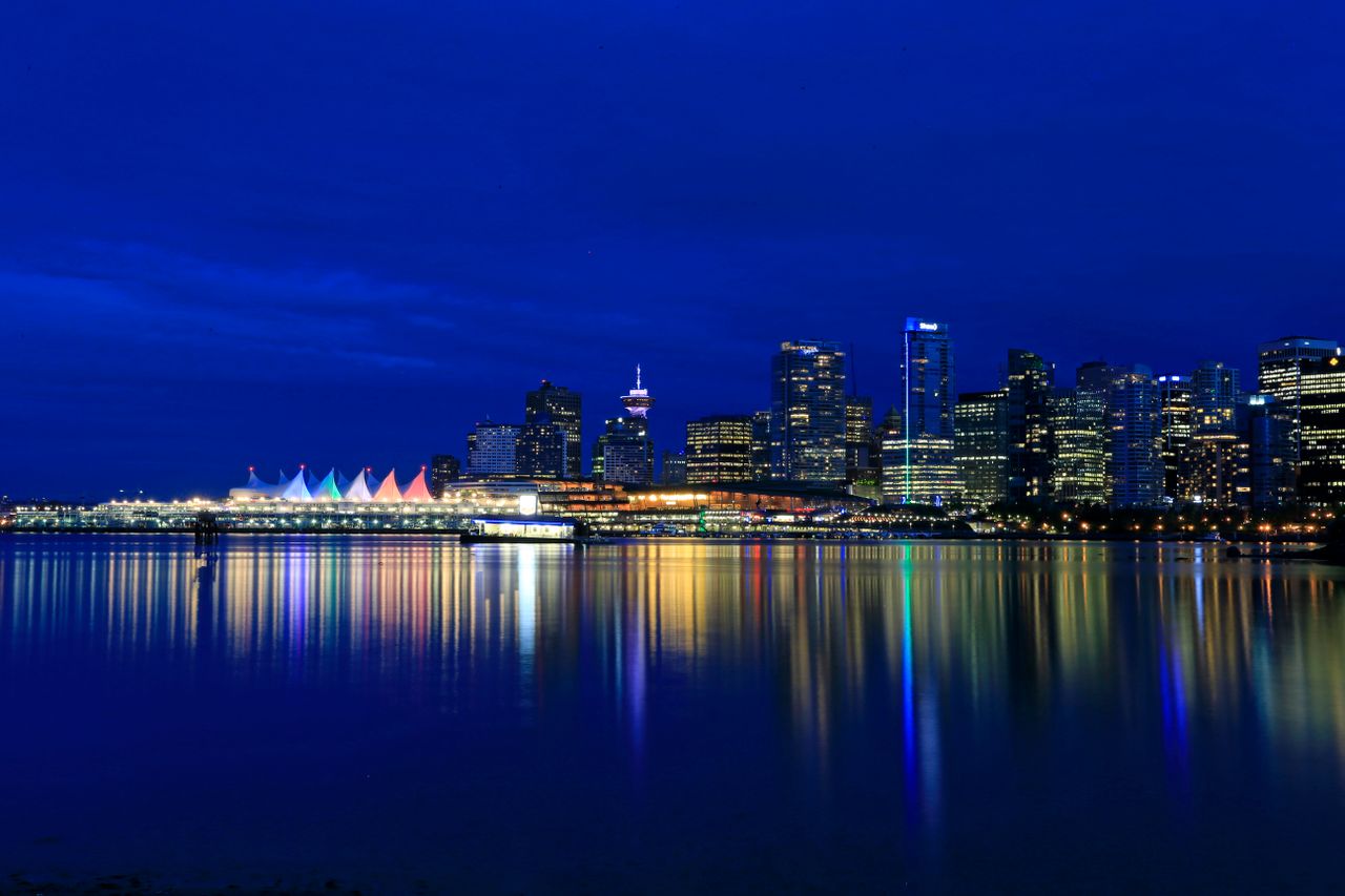 The Art of Drawing Readers In: Your attractive post title goes here Vibrant night view of Vancouvers illuminated skyline reflecting in the calm waterfront.
